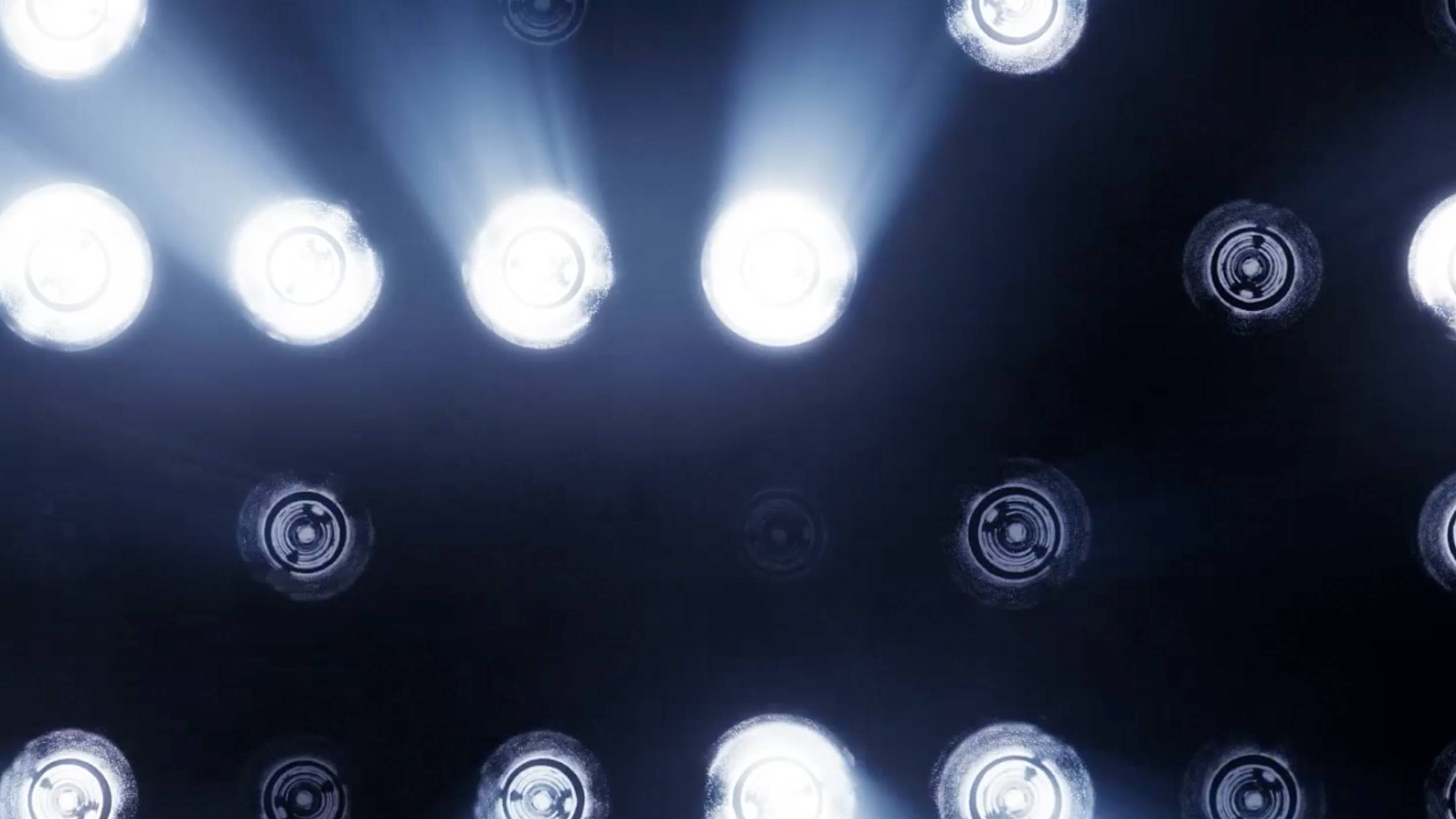 Hintergrund mit hellen, runden Scheinwerfern und Lichtstrahlen